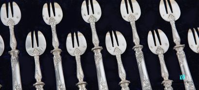 null Suite of twelve silver oyster forks, the handle stuffed with acanthus leaves...