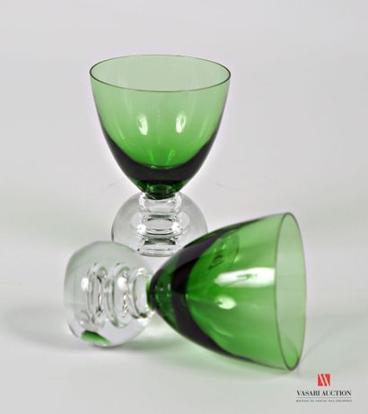 null Two glass liqueur glasses, the green tinted goblet of conical form rests on...
