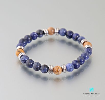 null Stretchable bracelet decorated with hourlite and lapis lazuli beads embellished...
