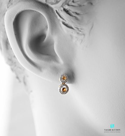 null Earrings in vermeil set with yellow tourmalines of round cut hemmed with zircons,...