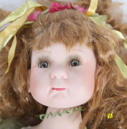 null Lot including a porcelain doll, a celluloid doll and a plastic doll.
The modern...