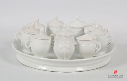 null Lot in white porcelain including ten cream pots and a round dish, the pots of...