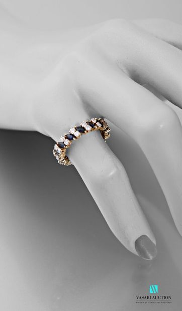 null American wedding band in 750 thousandths yellow gold set with navette sapphires...