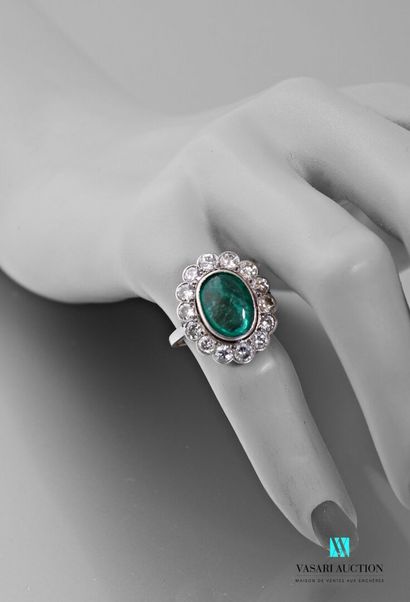 null Platinum Pompadour ring set with an emerald cabochon surrounded by fourteen...
