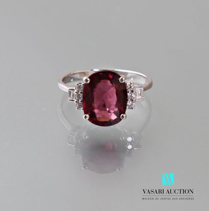 null Ring in 750 thousandths white gold set with an oval-cut rhodolite garnet weighing...