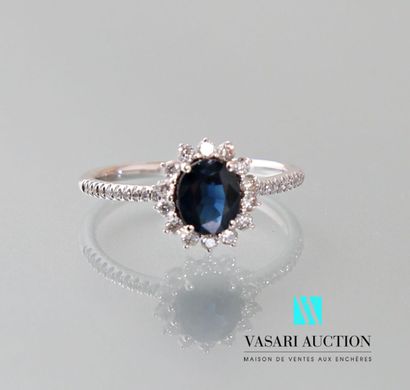 null Ring in 750 thousandths white gold set with an oval-cut sapphire weighing approximately...