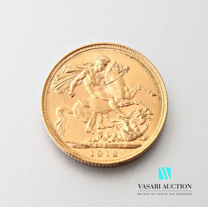 null A gold sovereign featuring King George V on the obverse and Saint George slaying...