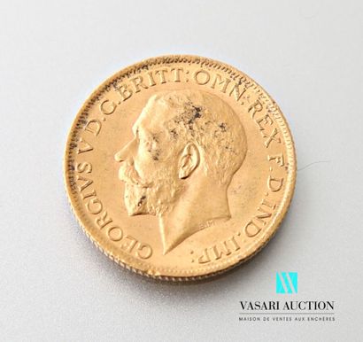 null A gold sovereign featuring King George V on the obverse and Saint George slaying...