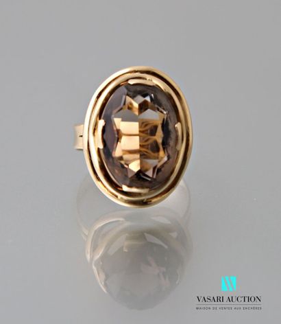 null Ring in yellow gold 750 thousandths set with an oval citrine in a double surround...