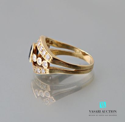 null Ring in yellow gold 750 thousandths set with an oval sapphire and adorned with...