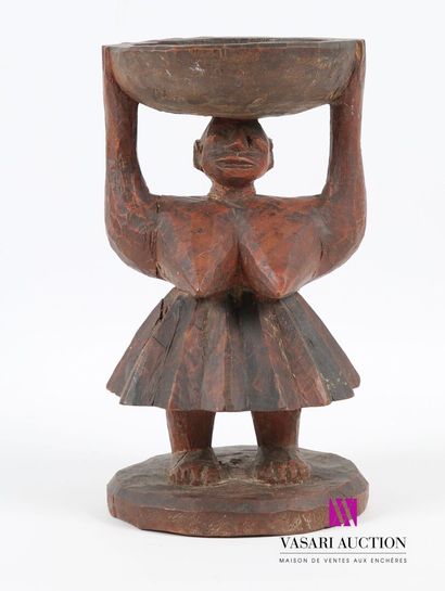 null Carved wooden bowl showing a woman in a pleated skirt holding a dish 
20th century
Height...