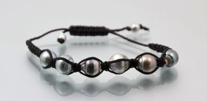 null Bracelet sur cordon de coton orné de six perles de Tahiti.