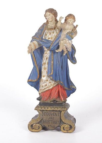 null Vierge en bois polychrome portant le Christ de la main gauche

Elle repose sur...