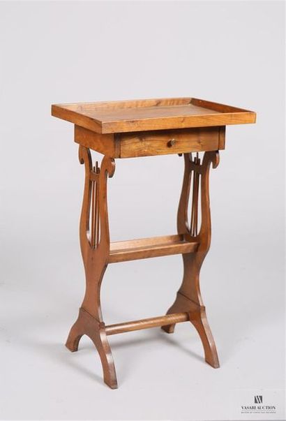 null Table travailleuse en bois naturel, elle présente un plateau rectangulaire ourlé...