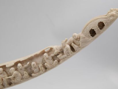 null JAPAN 
Elephant tusk with carved decoration of conversing figures in a landscape...