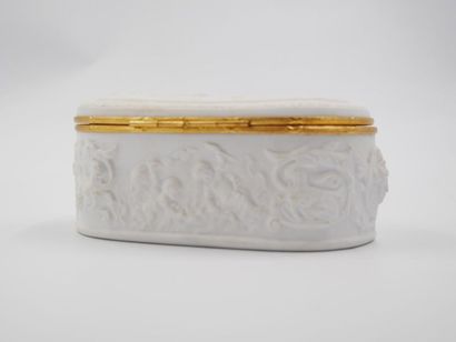 null Coquet, Limoges France: Oblong jewelry 
box in biscuit and gilded metal frame,...