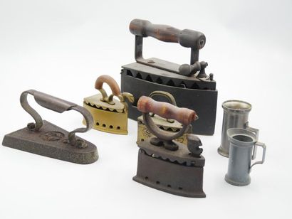 null Set of five cast iron or metal irons and two pewter measures 

[The successful...