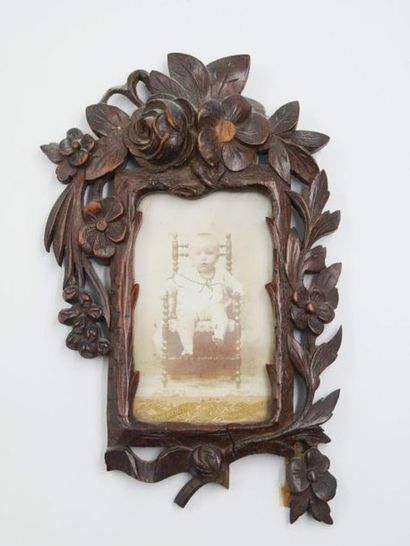 null Three carved natural wood frames with an openwork floral decoration and a small...