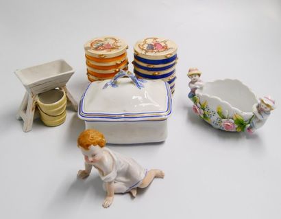 null Porcelain and earthenware set comprising: 
- a child's statuette in enamelled...