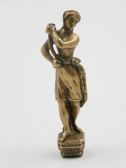 null Sceau à cacheter en bronze représentant une jeune femme. 
H. : 10,5 cm