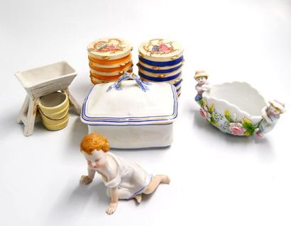 null Porcelain and earthenware set comprising: 
- a child's statuette in enamelled...