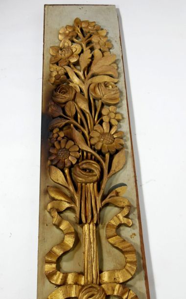 null Carved and gilded wood panelling element on a grey lacquered background, decorated...