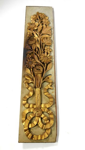 null Carved and gilded wood panelling element on a grey lacquered background, decorated...