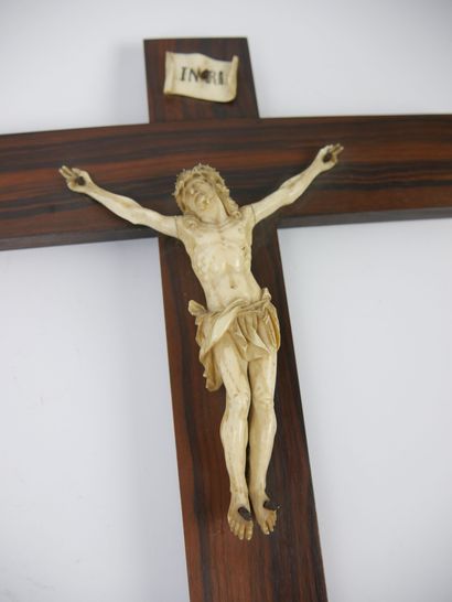 null Christ in carved bone, presented on a wooden cross and topped with an INRI plaque....