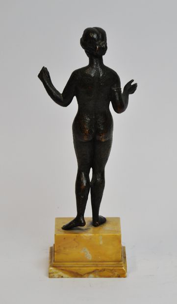 null A bronze statuette with a brown patina shaded with green, representing the goddess...