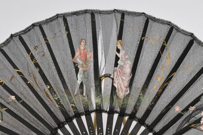 null Lot of two fans including : 

- A wood and black silk painted fan showing a...