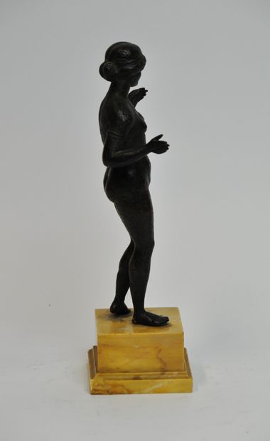 null A bronze statuette with a brown patina shaded with green, representing the goddess...