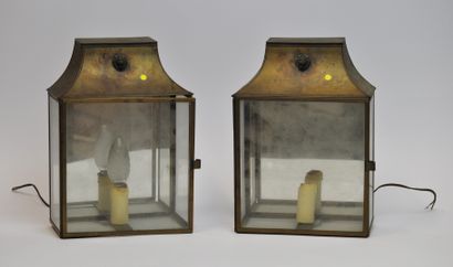 null A pair of rectangular gilt metal and glass lantern sconces, the upper part surmounted...
