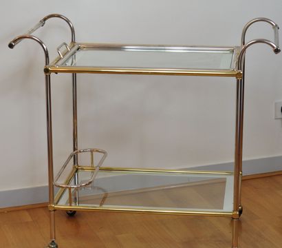 null Rolling sideboard in gilded and silvered metal with two glass trays and glass....