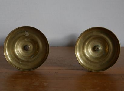 null A pair of gilt brass torches with a baluster shaft resting on a circular base....