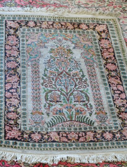 null Silk carpet with one border on a black background, the center decorated with...