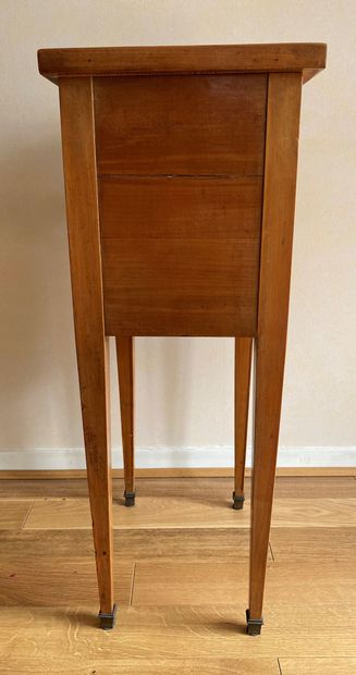 null Bedside table in fruitwood opening to three drawers resting on sheath feet finished...