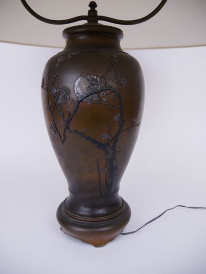 null JAPAN 

A bronze baluster lamp base decorated with flowering branches in light...