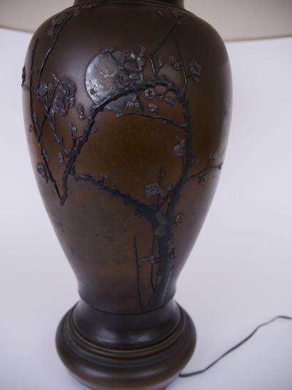 null JAPAN 

A bronze baluster lamp base decorated with flowering branches in light...