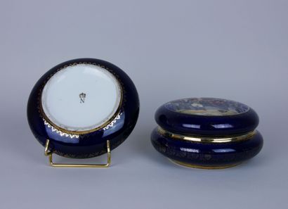 null CAPODIMONTE ? 

Two blue and gold porcelain bonbonnières representing scenes...