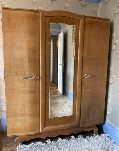 null Large cabinet opening with three doors, one of which has a glass bottom, the...