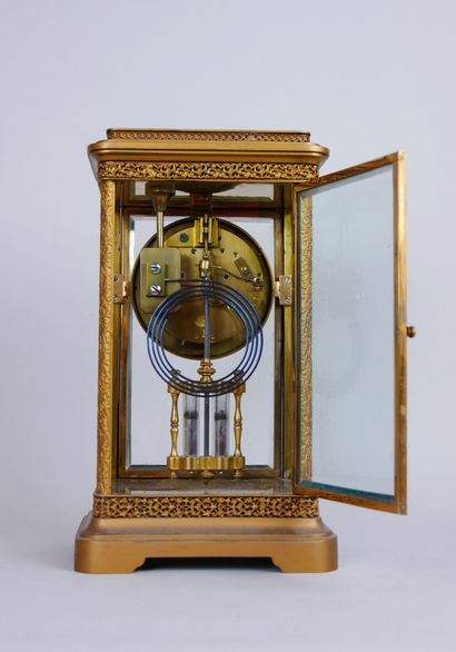 null Cage clock with brass frame presenting four faces in beveled glass, round white...