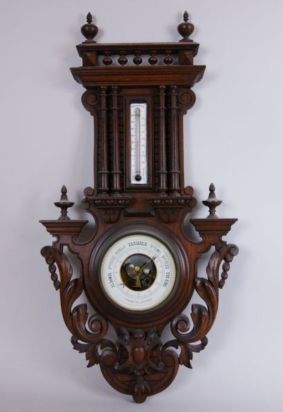 null Aneroid barometer with centigrade thermometer on a carved wooden stand decorated...