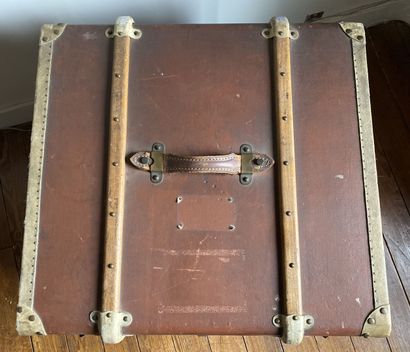 null Travel trunk with wood and metal reinforcements covered with a brown coated...
