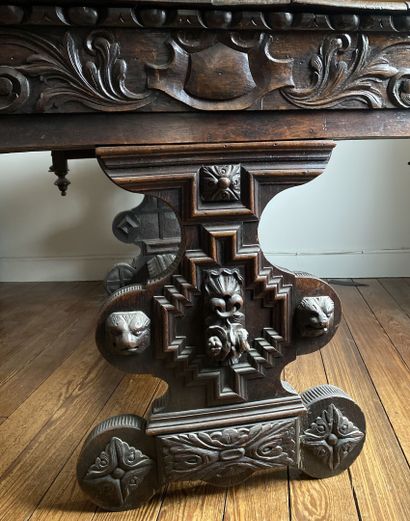null Rectangular shaped table in natural wood richly carved with scrolls and heads...