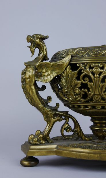 null Gilded and openwork brass planter decorated with 3 winged chimeras resting on...