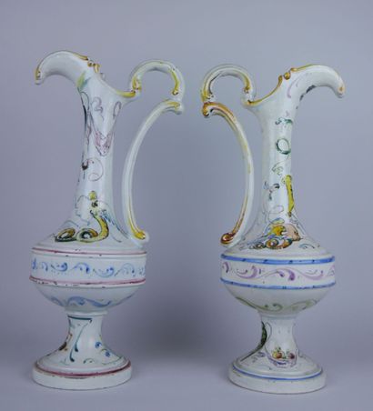 null Pair of white earthenware ewers with enamelled decoration of foliage, birds...