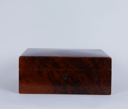null Mahogany and burl wood jewelry box centered with a stained wood cartouche. The...