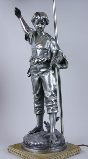 null Lamp stand in silver plated metal representing a young fisherman holding a fish...