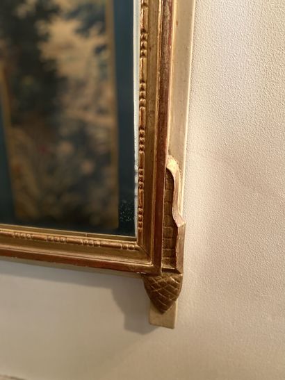 null The frame is made of carved and gilded wood on a cream lacquered background.

Louis...