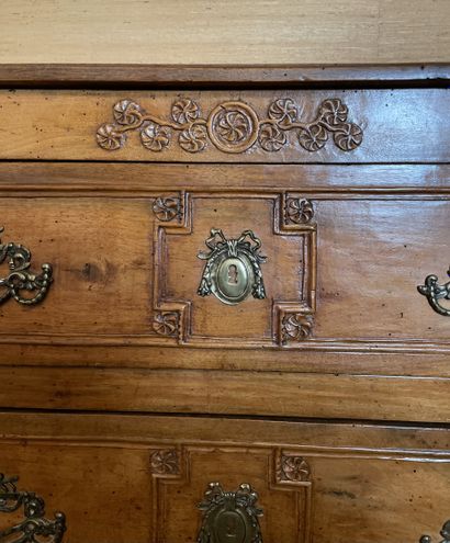 null Rectangular chest of drawers in molded and carved walnut decorated with rosettes...